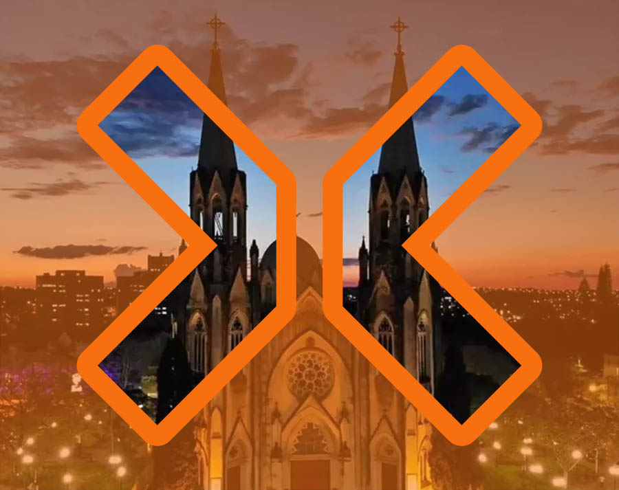 Vista aerea da cidade alaranjada com visão nítida somente dentro do grande X do logotipo da TRIX vazado.